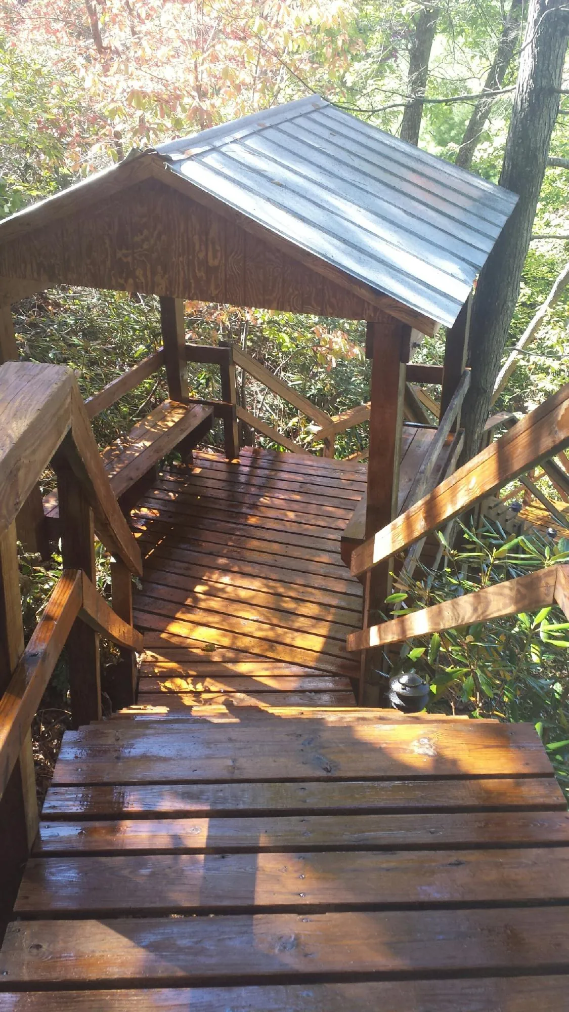 Freshly stained wood walkway and covered shelter with a metal roof in Wellsville